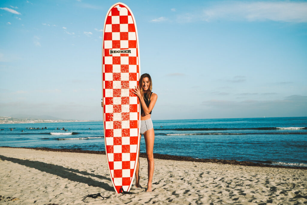 surfer girl holding surfboard