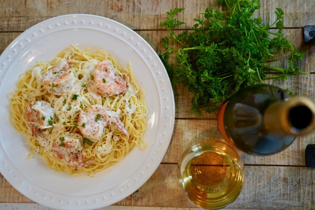 creamy garlic shrimp over pasta with wine