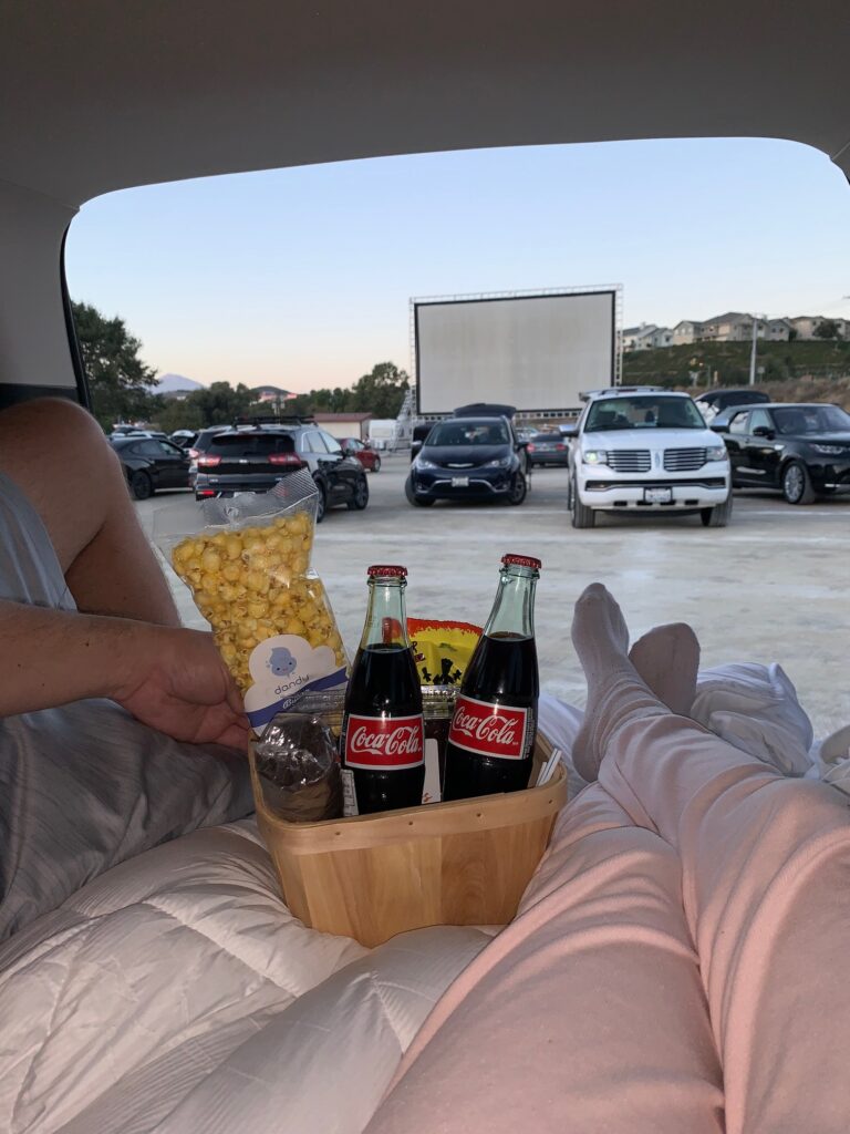 drive in movie theatre and popcorn in the back of a car watching a movie