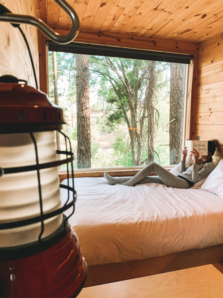 girl sitting on a cabin bed at getaway house