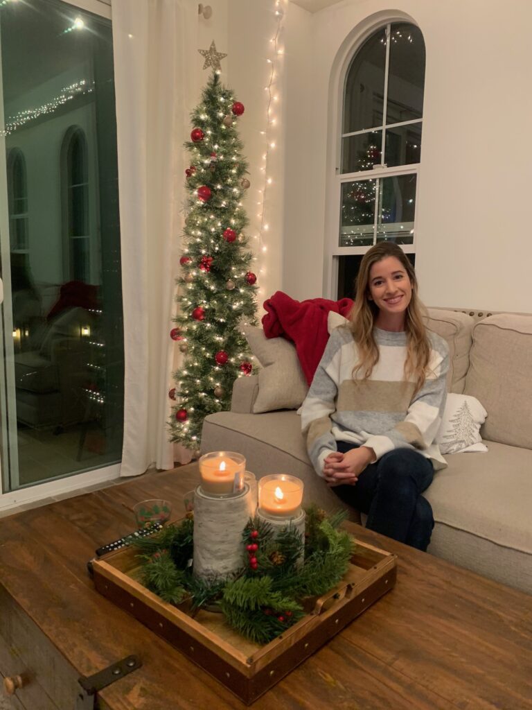 me sitting on the couch next to a christmas tree