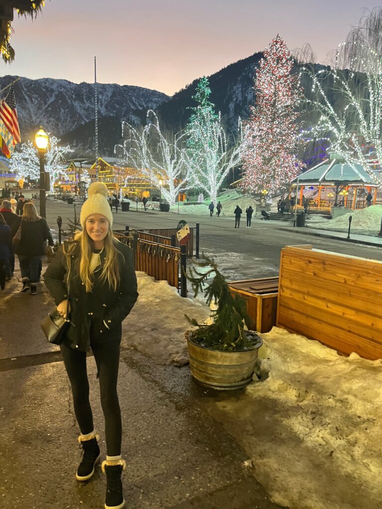 girl standing in the street of leavenworth with at the christmas lights festival